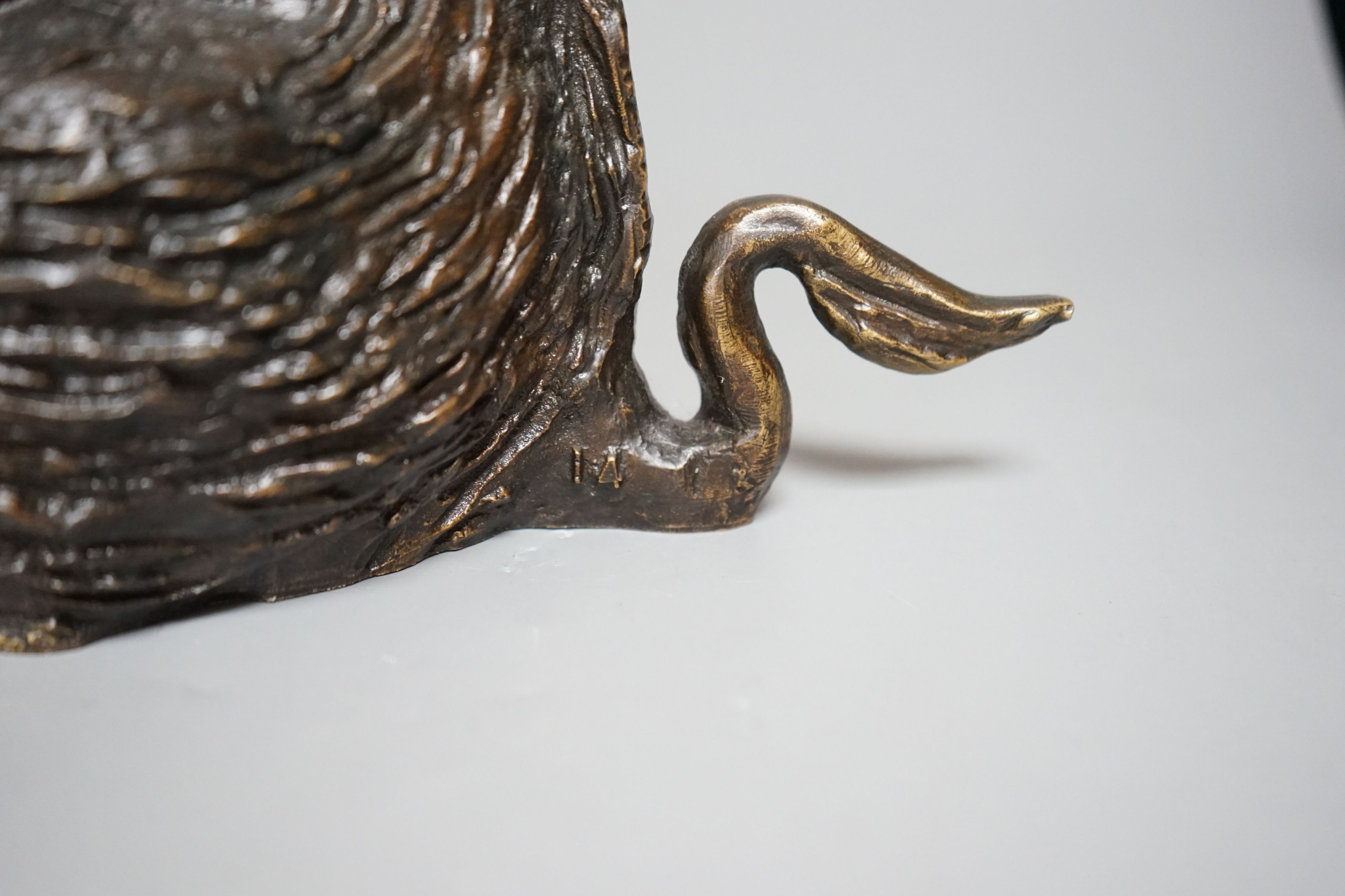 A 20th century cast bronze model of a seated boar, numbered ‘14’, height 24cm